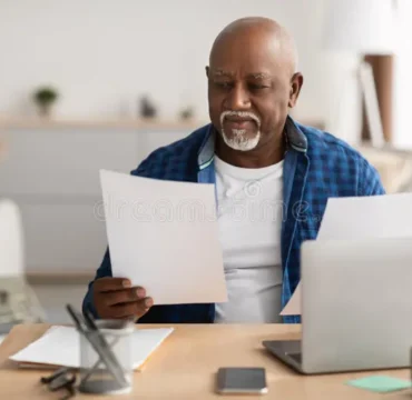 mature-black-businessman-working-papers-sitting-laptop-indoor-mature-black-businessman-working-papers-sitting-236807719